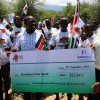 Commissioner Hon. Dorcas Kedogo (right)handing over a cheque to the Pokot and Marakwet youth who had jointly cleared the road that join Chesongoch and Tilingwa on 21st September, 2020 to ease movement between the two communities.